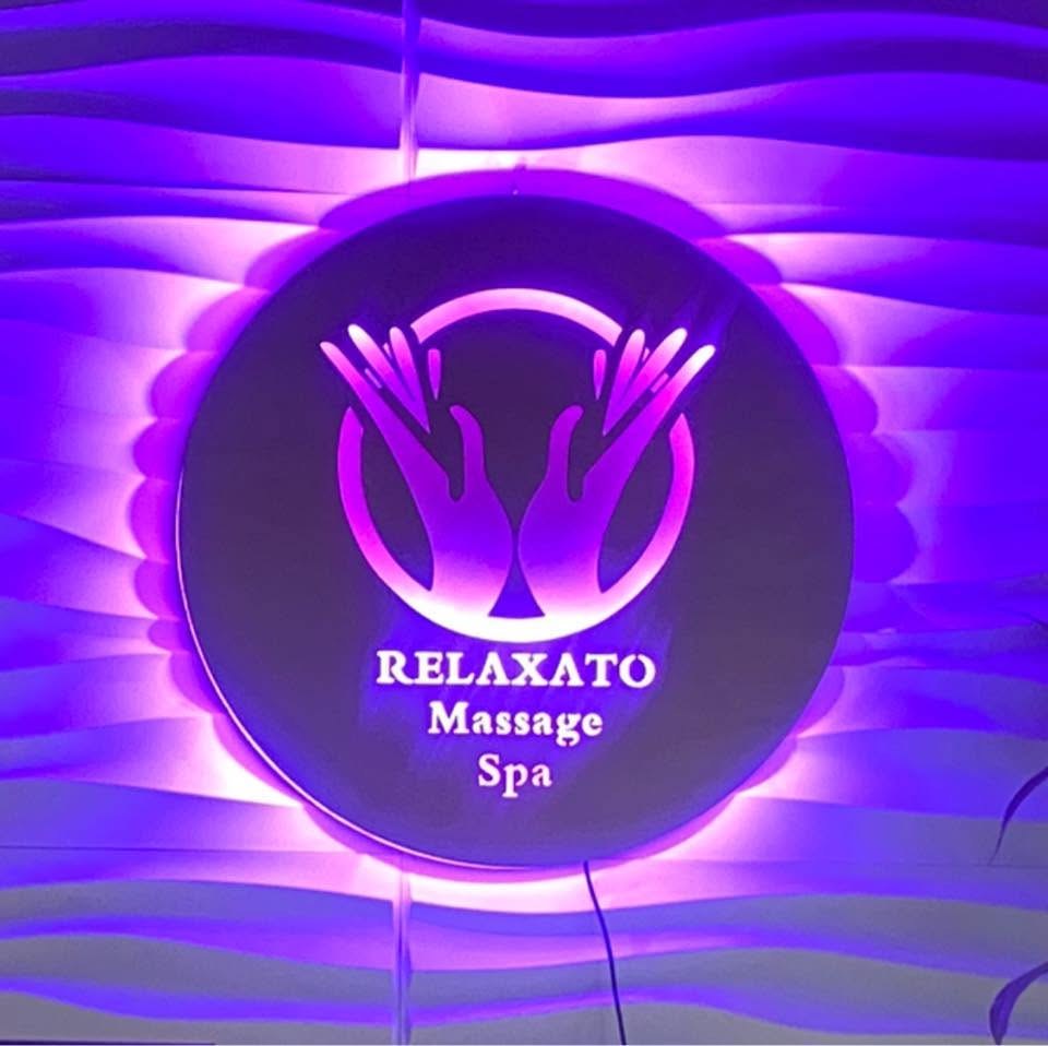 The glowing Relaxato Massage Spa signage